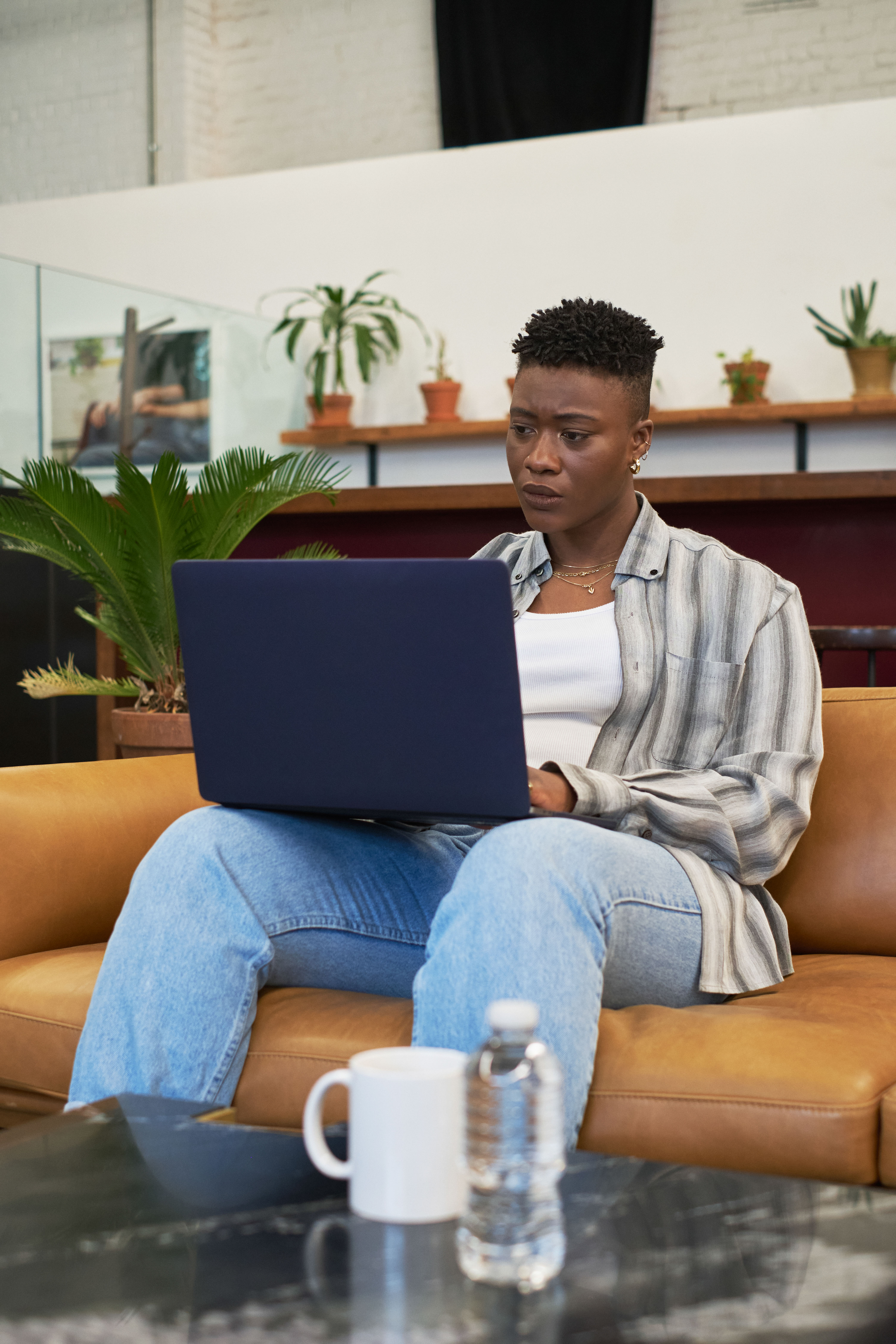 A non-binary person using a laptop at work(2)